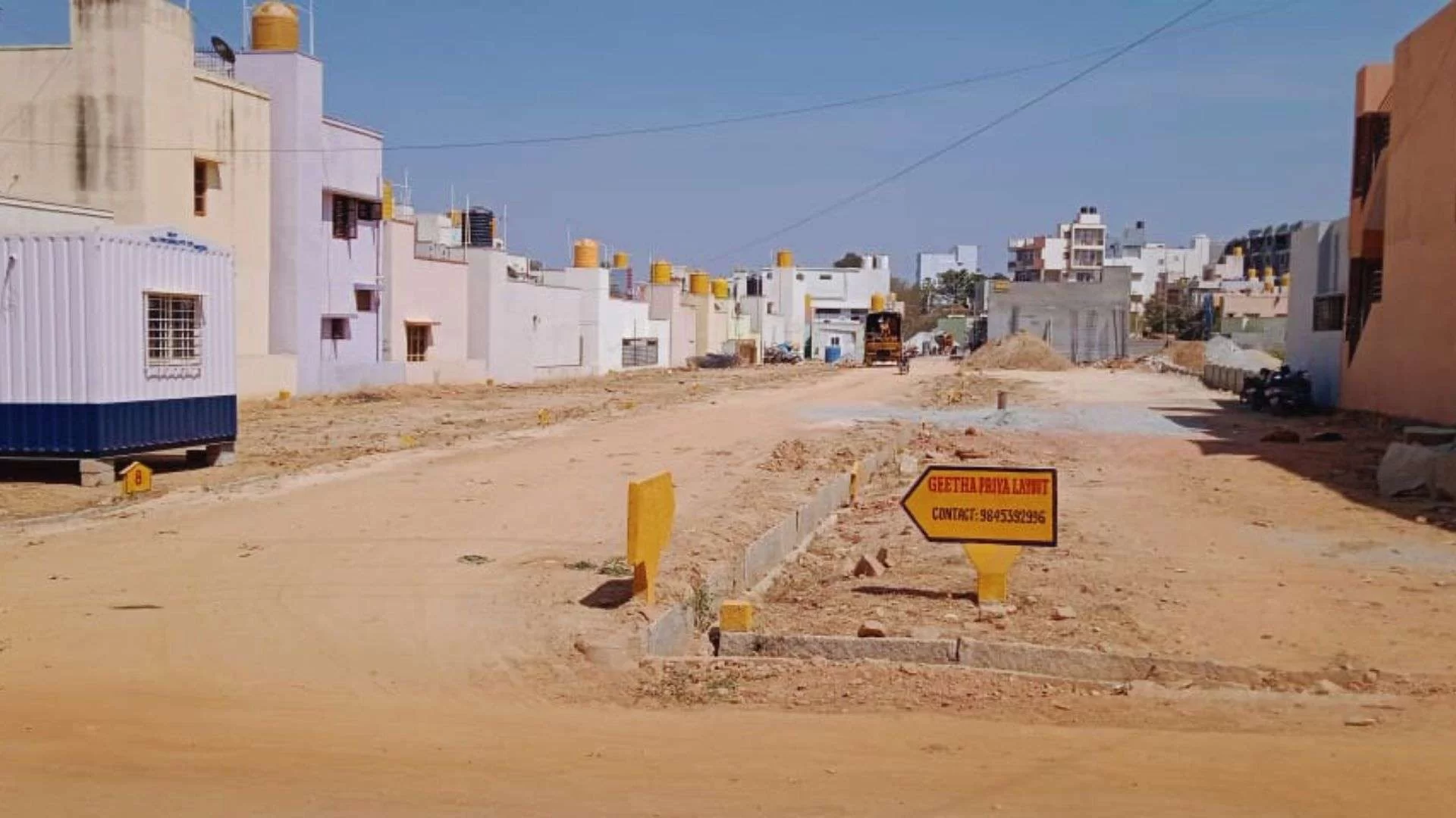 Master plan map of Geetha Priya Layout showing marked plot dimensions, cement roads, and community amenities near KR Puram.