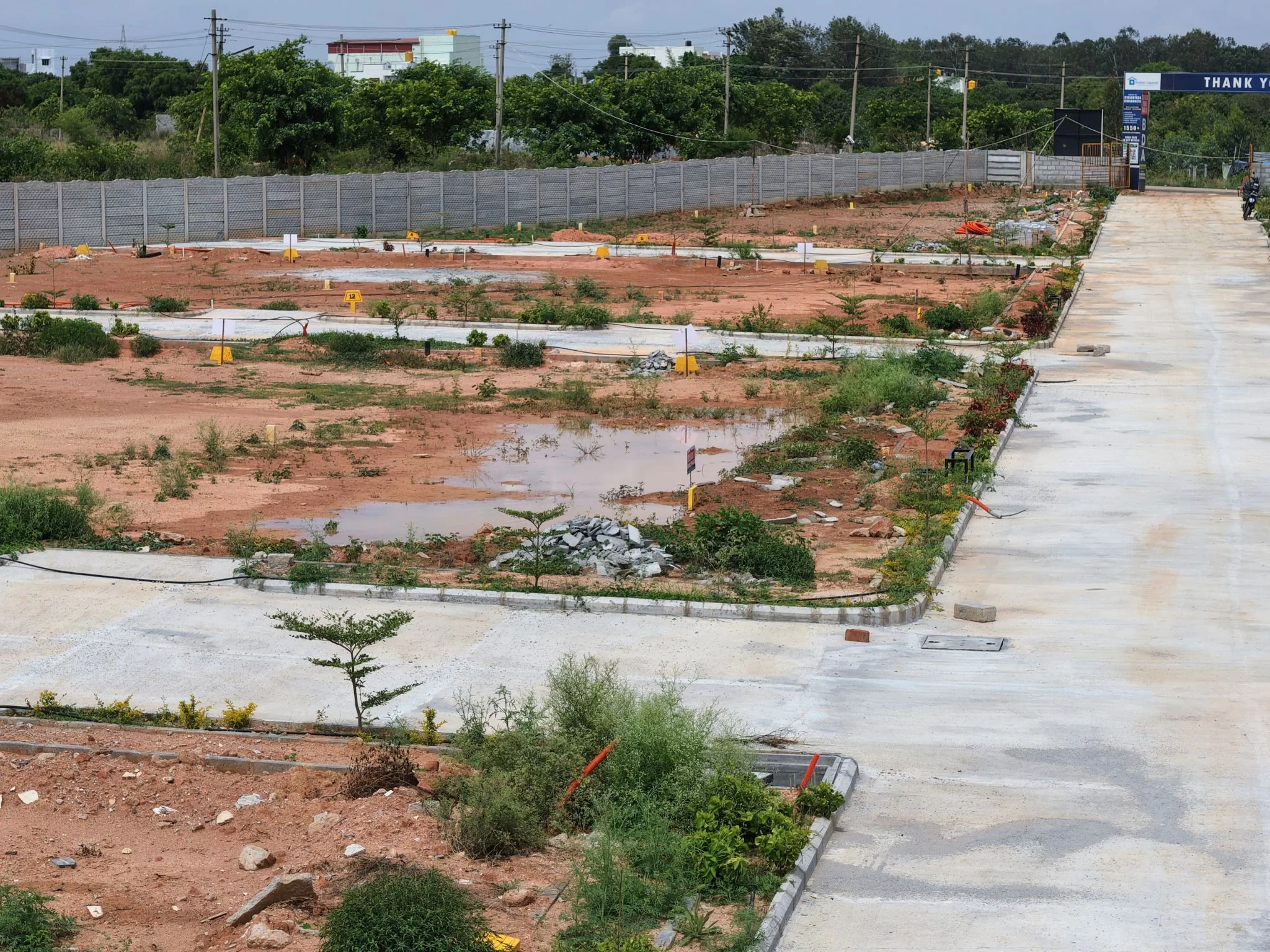 Ready-to-construct individual residential plots at Shelter Enclave, featuring levelled ground and clear plot markings.